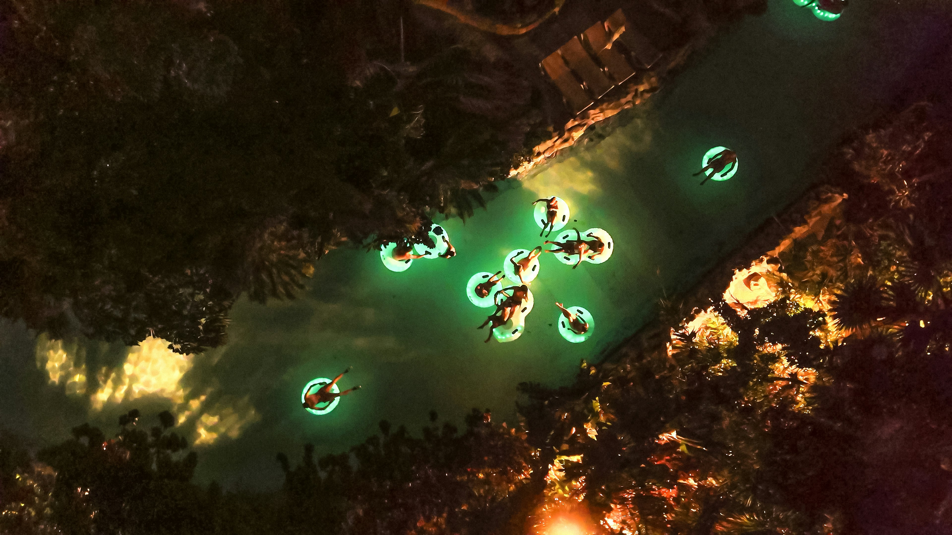 aerial view of tourists enjoying water park slides at night