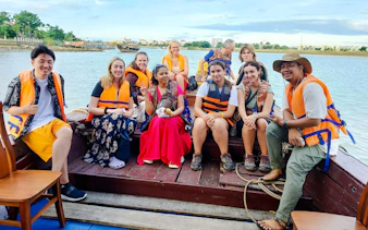 Tourists wearing life jackets on a boat ride along the Mekong Delta, Vietnam.