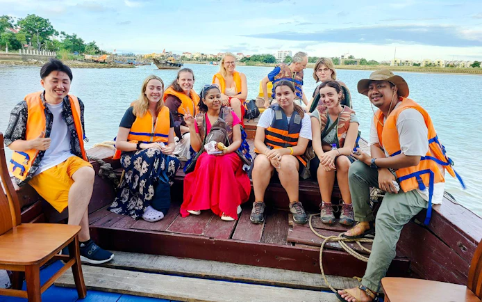 Tourists wearing life jackets on a boat ride along the Mekong Delta, Vietnam.