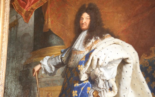 Portrait of a regal figure in ornate attire at the Louvre Museum, Paris.