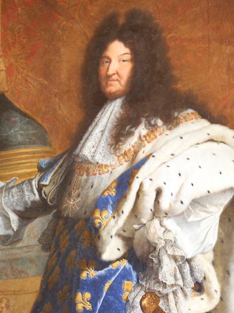 Portrait of a regal figure in ornate attire at the Louvre Museum, Paris.