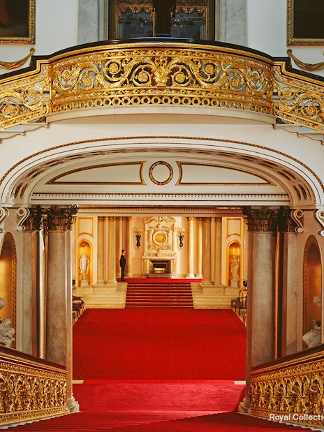 Grand Staircase with ornate gold railings at Buckingham Palace, London.