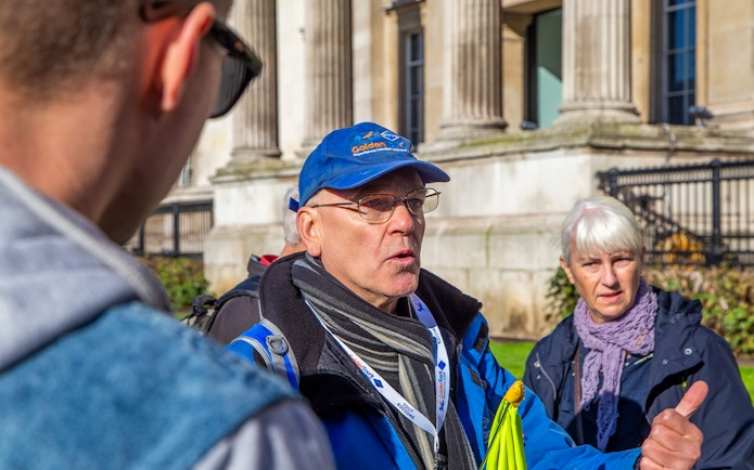 Guide leading guests at Buckingham Palace State Rooms tour.