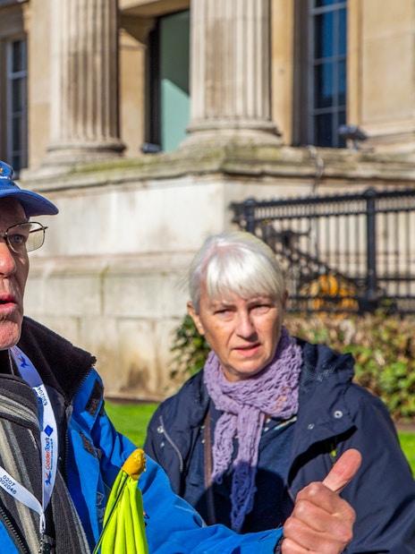 Guide leading guests at Buckingham Palace State Rooms tour.