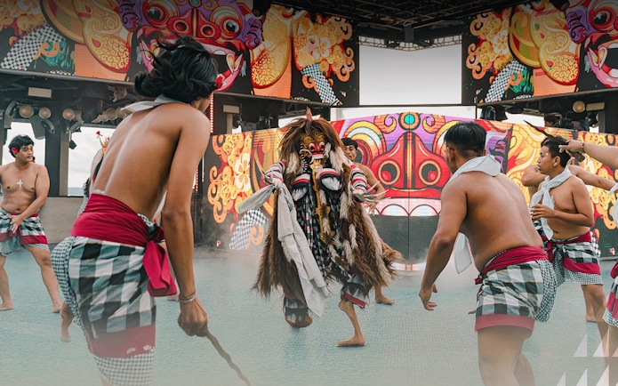 Traditional dance performance at Atlas Beach Club with vibrant costumes and masks.