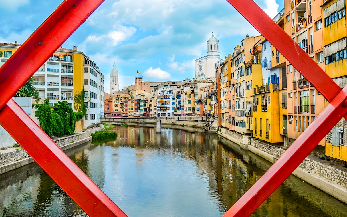 Onyar River with colorful houses and Eiffel Bridge in Girona, Catalonia, Spain.