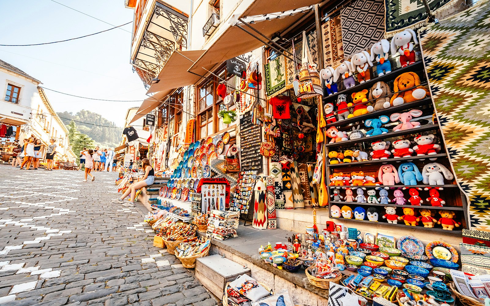 Souvenir shops with colorful crafts and toys in old town Gjirokaster, Albania.
