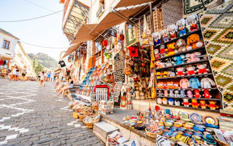 Souvenir shops with colorful crafts and toys in old town Gjirokaster, Albania.