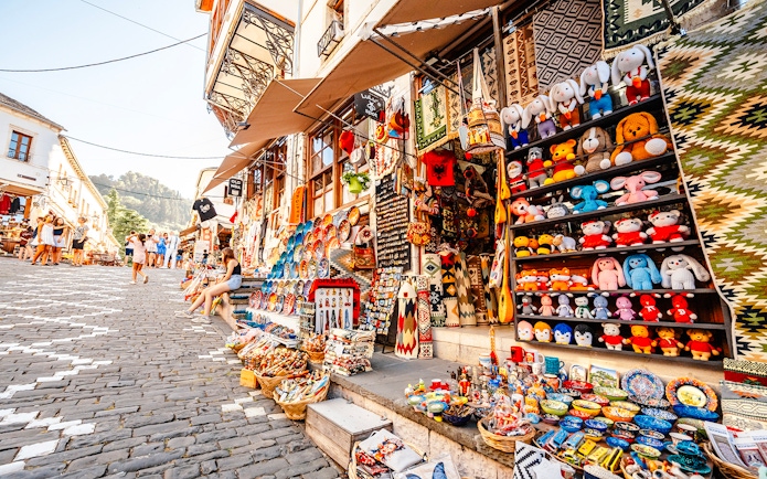 Souvenir shops with colorful crafts and toys in old town Gjirokaster, Albania.