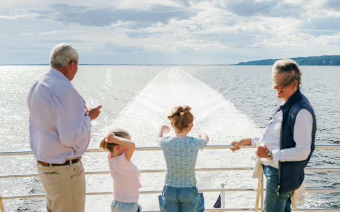 Old couple and kids enjoying the view on a World Heritage Cruise on Gordon River.