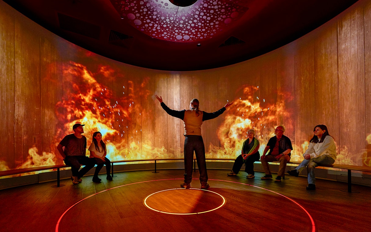 Interactive sensory experience with fiery visuals in a Scottish exhibit.