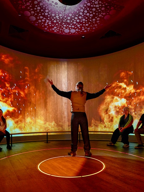 Interactive sensory experience with fiery visuals in a Scottish exhibit.