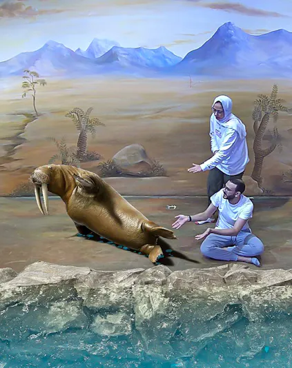 Visitors interacting with a 3D walrus illusion at Illusion 3D Art Museum.