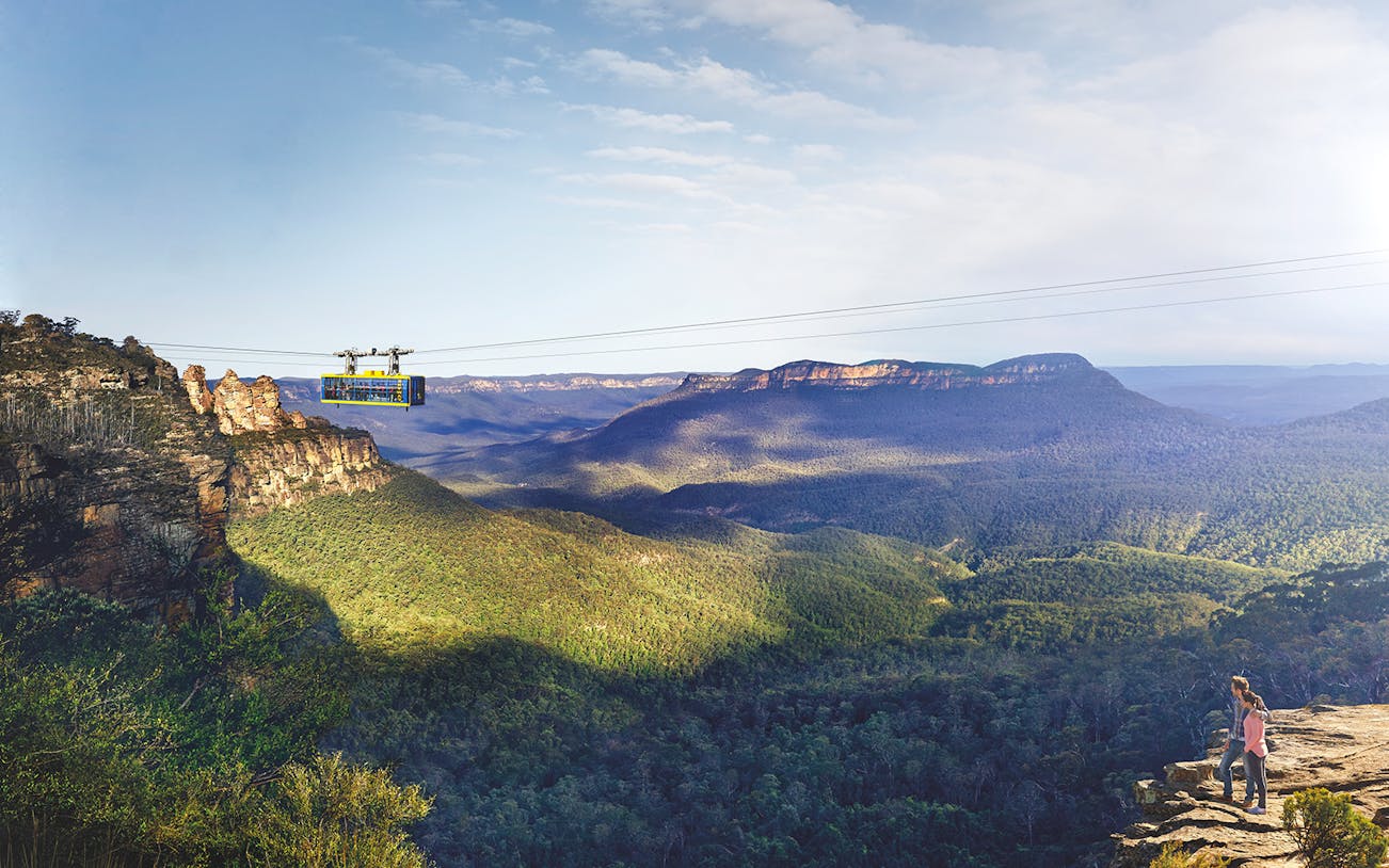 Cableway at Scenic World, Blue Mountains with passengers above forested landscape.