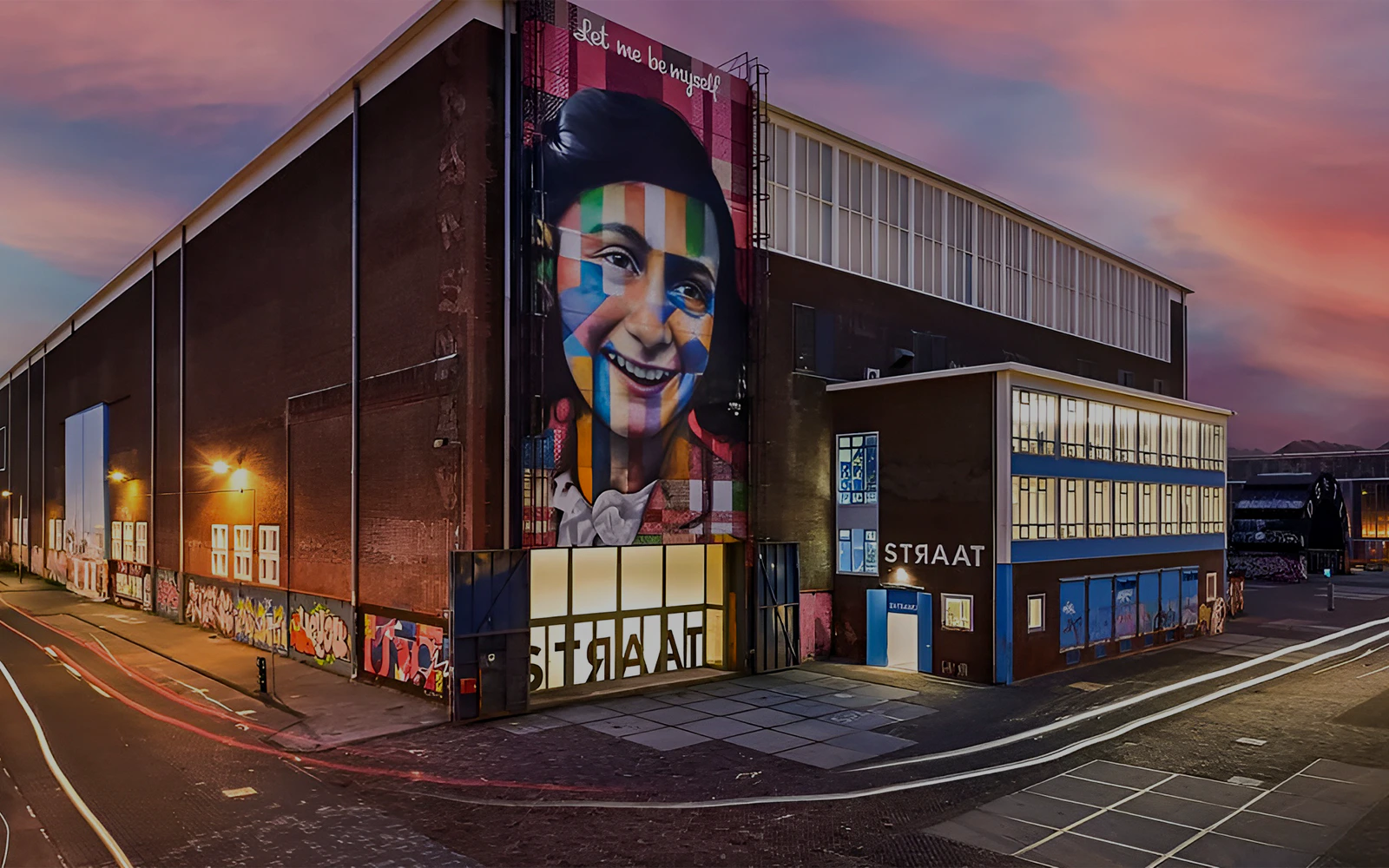 STRAAT Museum exterior with vibrant mural at sunset, Amsterdam.