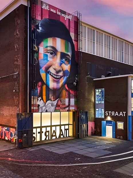 STRAAT Museum exterior with vibrant mural at sunset, Amsterdam.