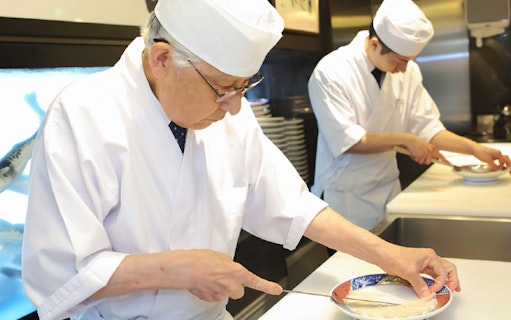 Chefs preparing puffer fish dishes at Torafugu-tei Ginza restaurant.