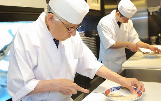 Chefs preparing puffer fish dishes at Torafugu-tei Ginza restaurant.