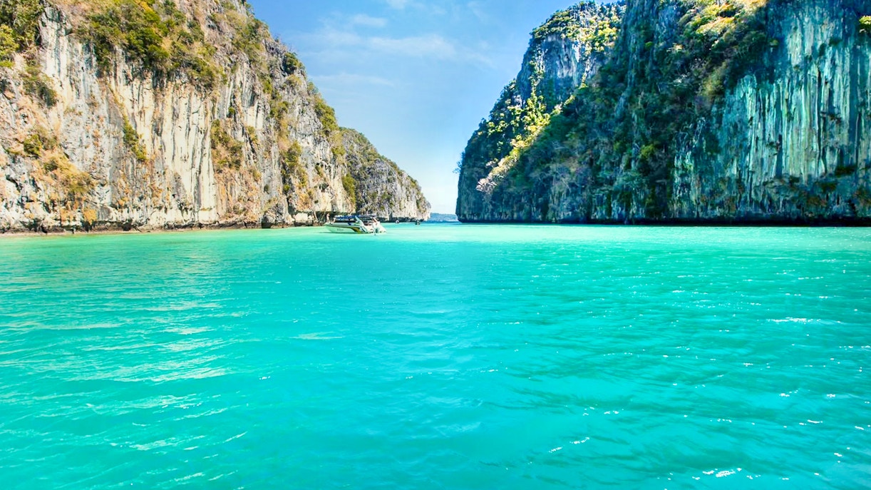 Boat sailing to Maya Bay through limestone cliffs, Phi Phi Islands