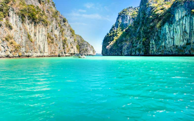 Boat sailing through limestone cliffs towards Maya Bay, Phi Phi Islands.