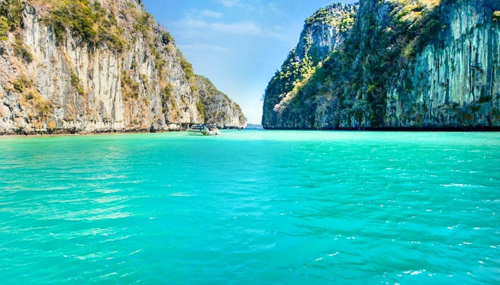 Boat sailing to Maya Bay through limestone cliffs, Phi Phi Islands