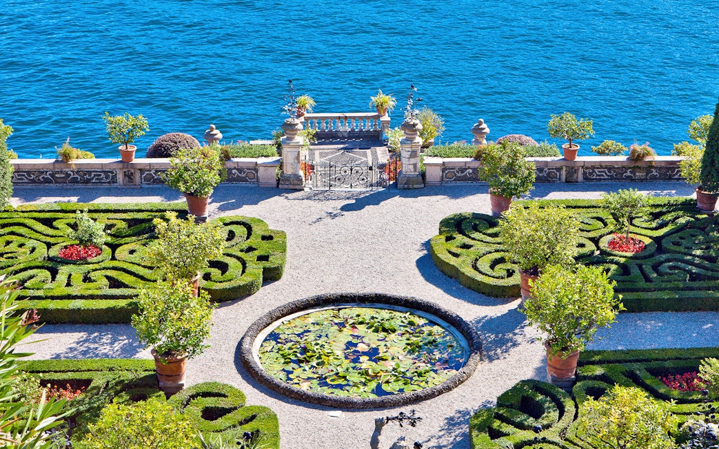 Isola Bella garden with ornate hedges and lily pond overlooking Lake Maggiore.