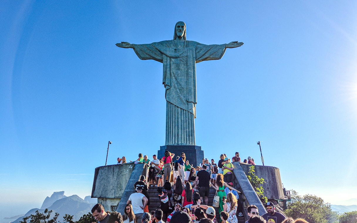 Tourists gather at the base of Christ the Redeemer statue in Rio de Janeiro, Brazil.