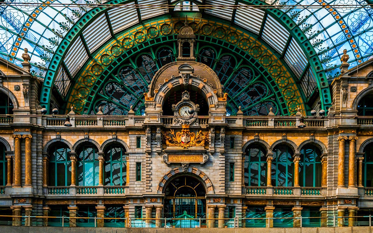 Interior of Antwerpen-Centraal station with ornate architecture and clock in Antwerp, Belgium.