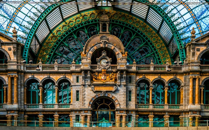 Interior of Antwerpen-Centraal station with ornate architecture and clock in Antwerp, Belgium.
