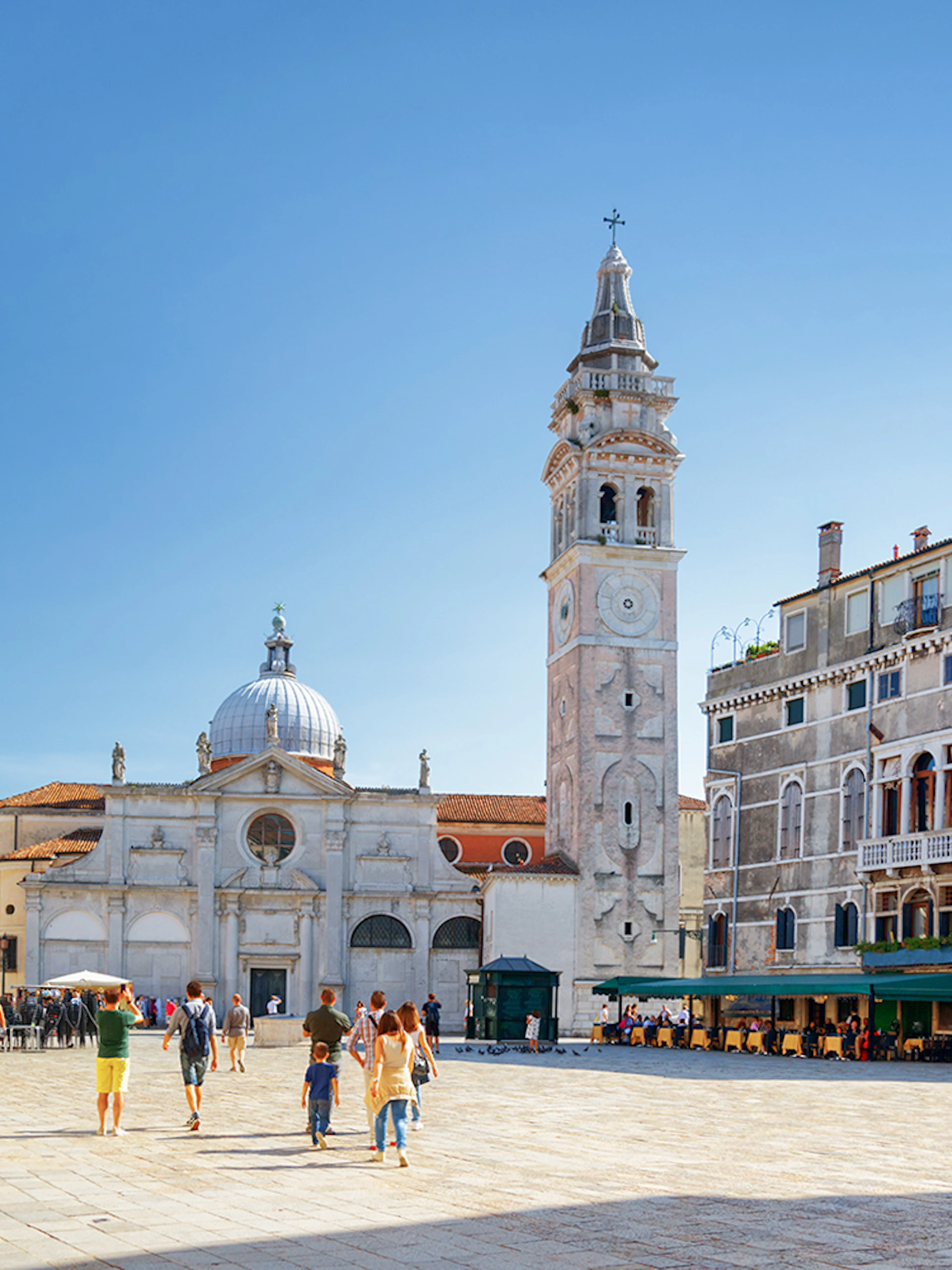 Venice walking tour with people in a piazza near San Giorgio dei Greci church.