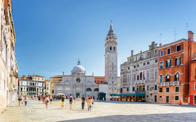 Venice walking tour with people in a piazza near San Giorgio dei Greci church.