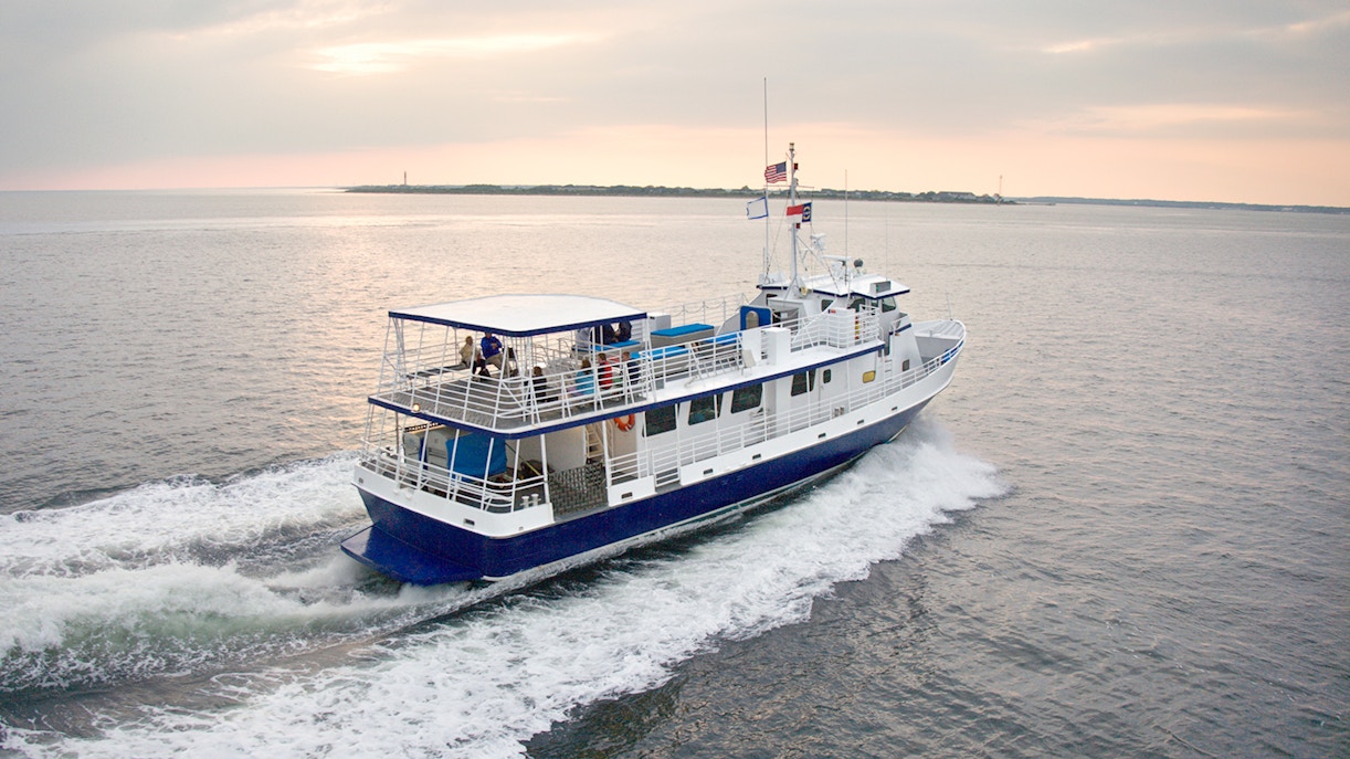 Passenger ferry boat traveling across calm waters.