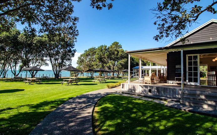 Lawn and picnic area by the sea on Auckland's Tikapa Moana cruise.