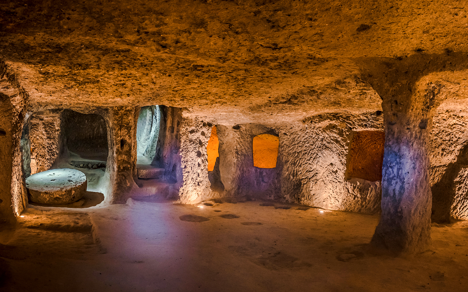Inside view of Kaymaklı Underground City in Cappadocia, showcasing ancient carved rooms and passageways.