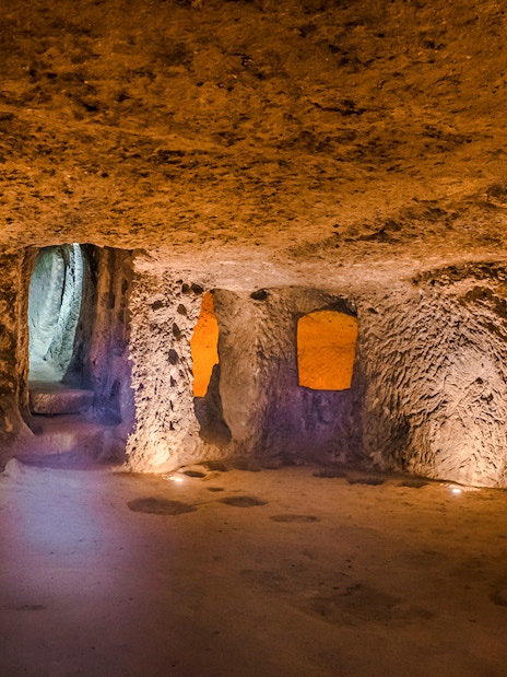 Inside view of Kaymaklı Underground City in Cappadocia, showcasing ancient carved rooms and passageways.