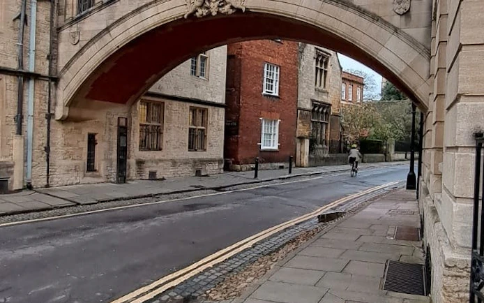 Historic Oxford street under the Bridge of Sighs, part of the self-guided city exploration game.