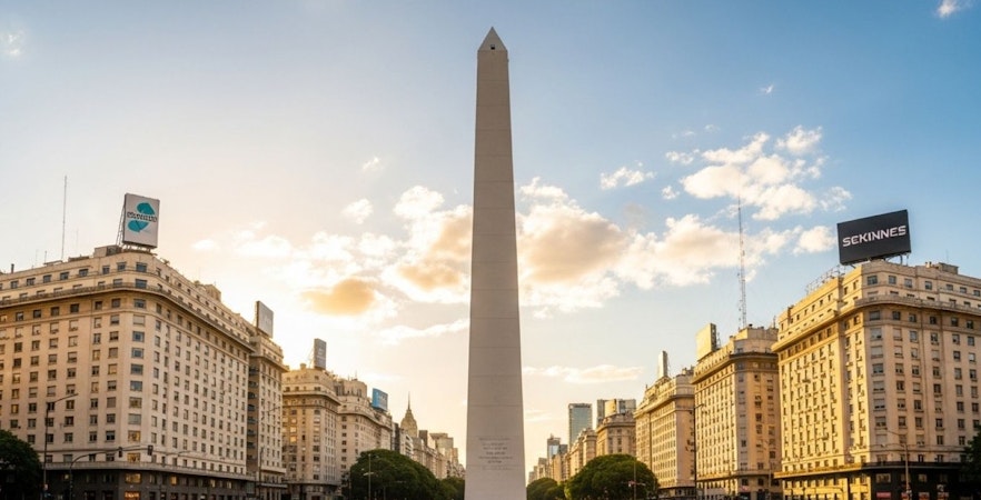 Obelisco de Buenos Aires with surrounding buildings at sunset.