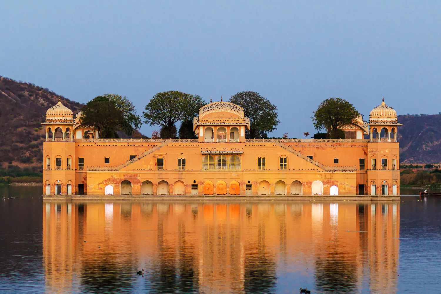 Jal Mahal palace in Jaipur reflecting on Man Sagar Lake during a sightseeing tour.