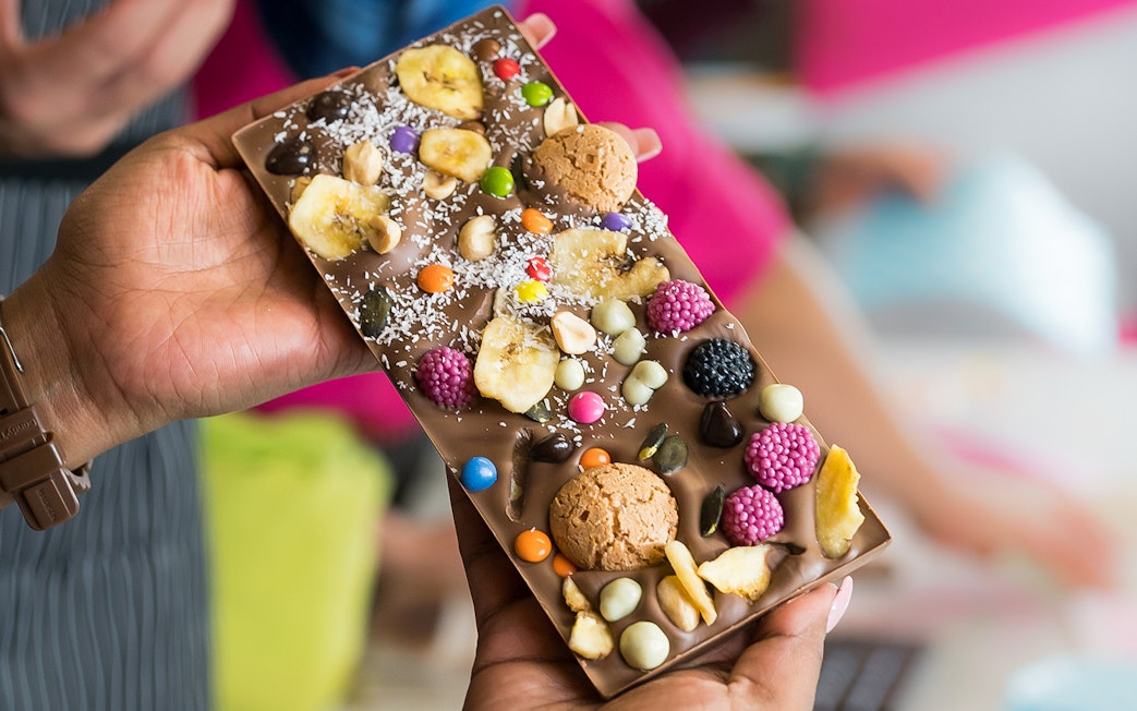 Chocolate bar with assorted toppings at Vienna chocolate workshop.