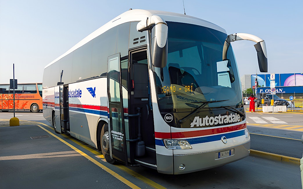 Autostradale Airport Transfer bus parked at airport terminal.
