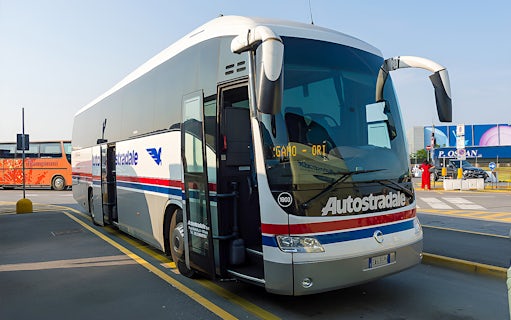 Autostradale Airport Transfer bus parked at airport terminal.