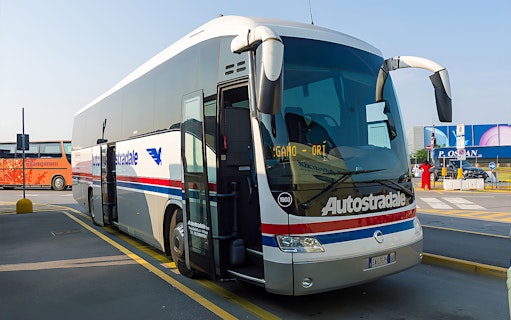 Autostradale Airport Transfer bus parked at airport terminal.