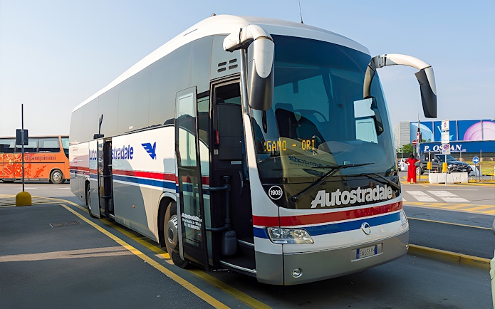 Autostradale Airport Transfer bus parked at airport terminal.