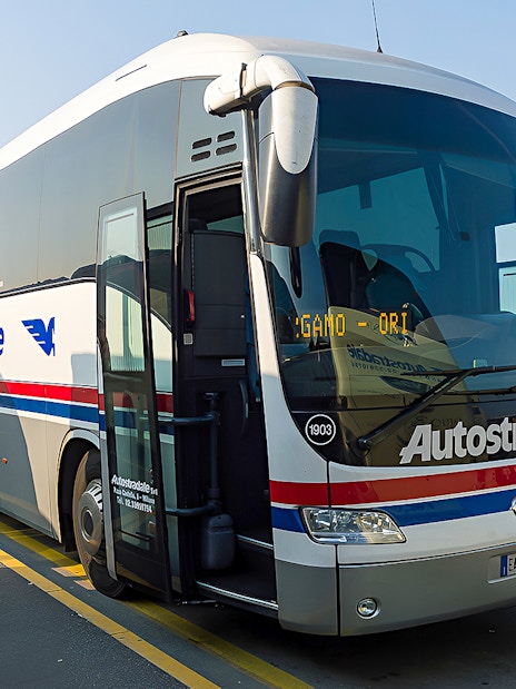 Autostradale Airport Transfer bus parked at airport terminal.