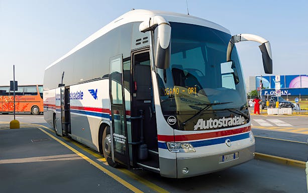 Autostradale Airport Transfer bus parked at airport terminal.