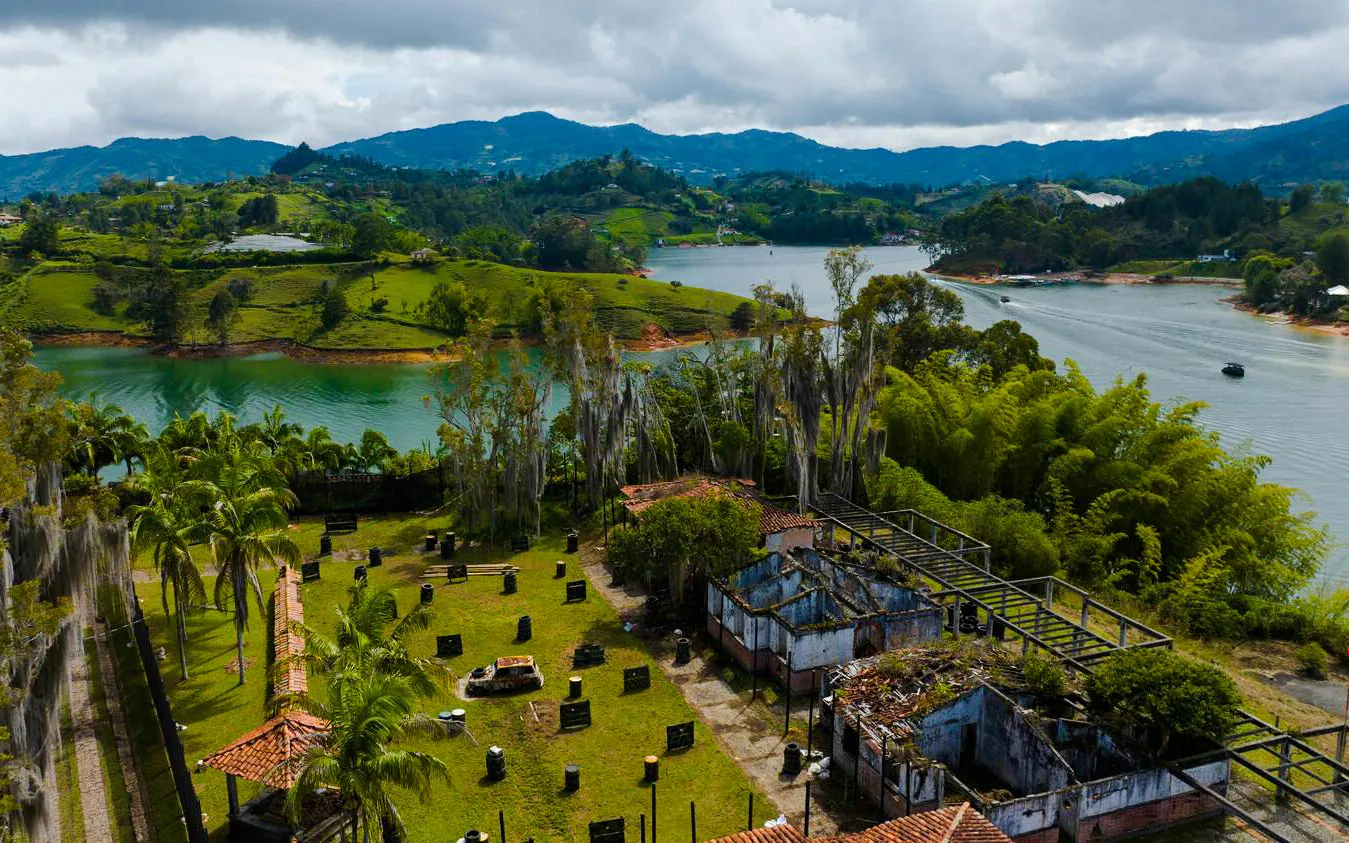Aerial view of Peñol-Guatapé Reservoir with lush greenery and ruins in Colombia.