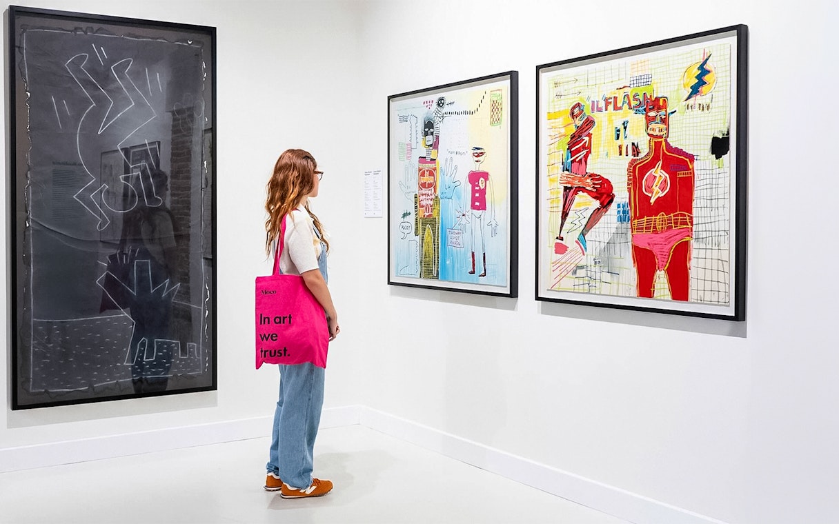 Visitor observing contemporary art at Moco Museum, Barcelona.