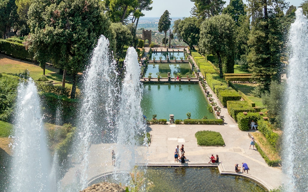 Tourists enjoying the fountains and gardens of Villa d'Este in Tivoli, Italy.