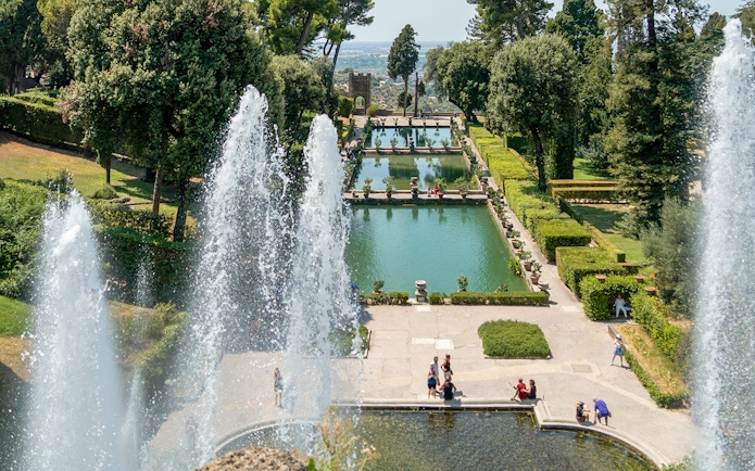 Tourists enjoying the fountains and gardens of Villa d'Este in Tivoli, Italy.