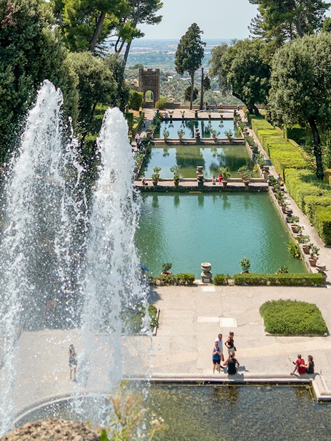 Tourists enjoying the fountains and gardens of Villa d'Este in Tivoli, Italy.